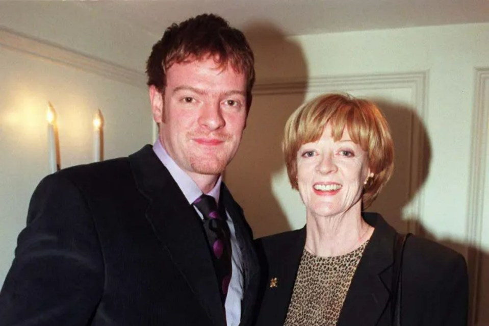 a man in a suit and tie stands next to an older woman