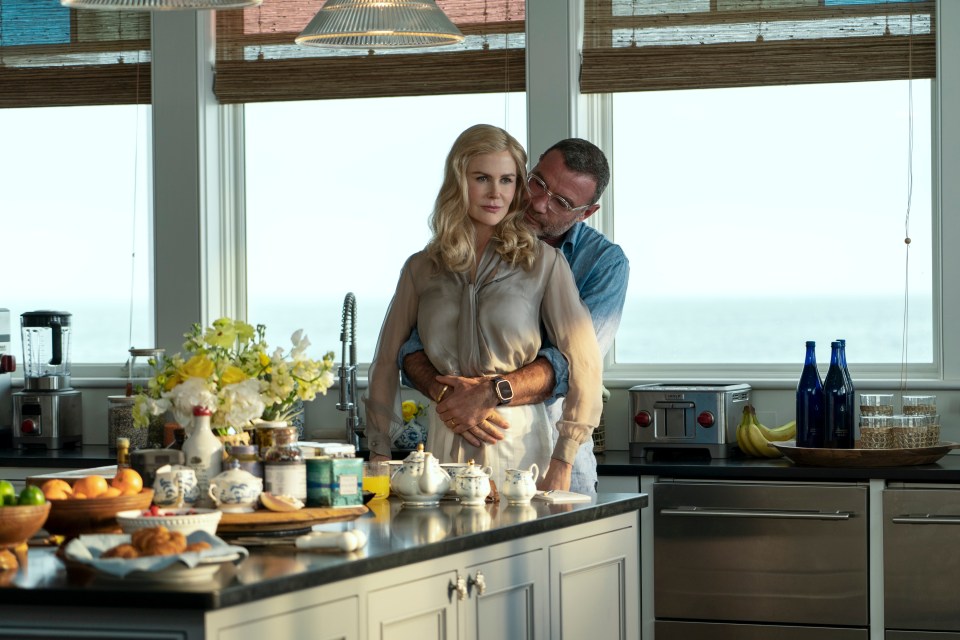 a man and a woman are hugging in a kitchen