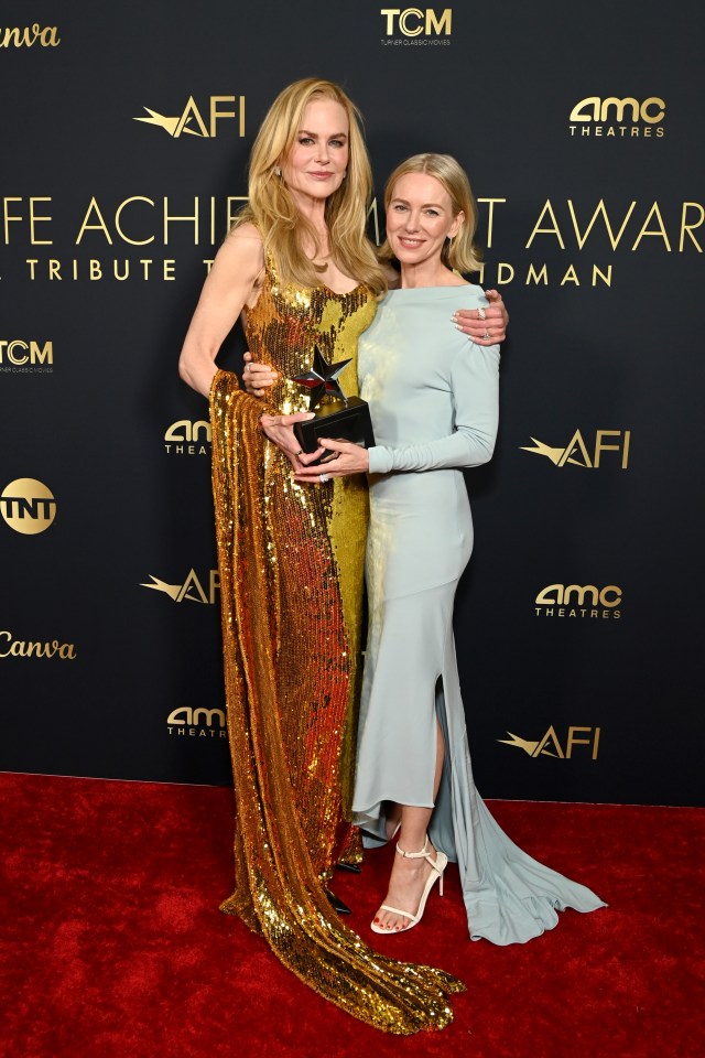 two women on a red carpet with the word afi on it