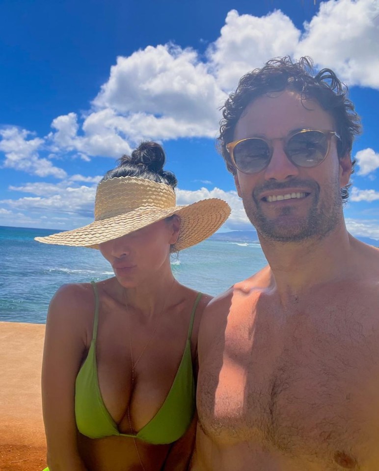 Nicole pictured in a stunning green bikini with her boyfriend Thom Evans