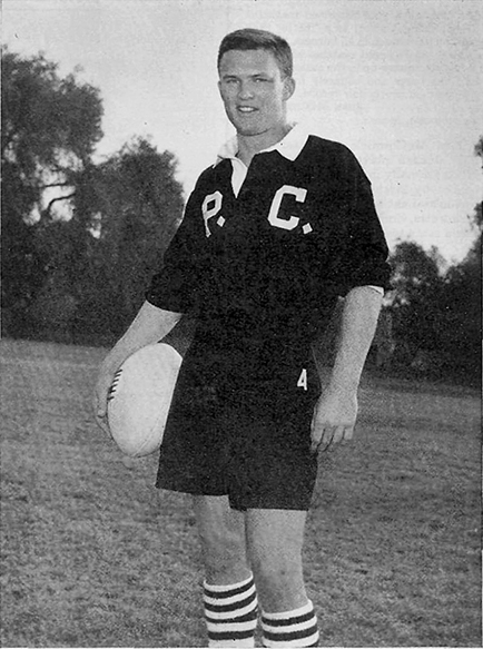 a man in a p.c. jersey holds a rugby ball