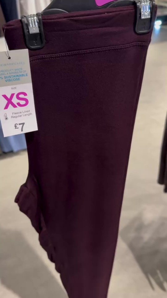 a pair of purple leggings with a tag that says xs