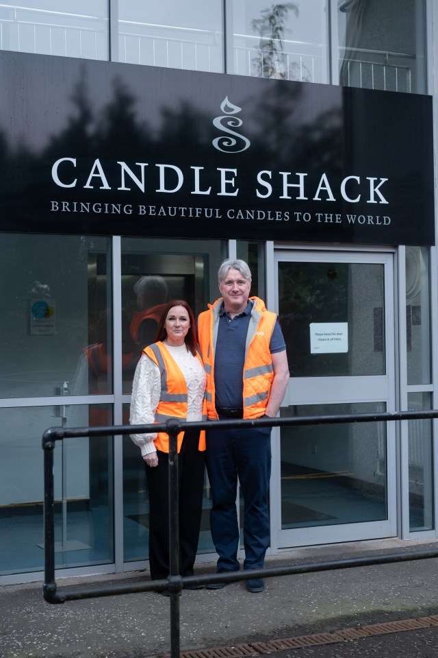 two people standing in front of a candle shack