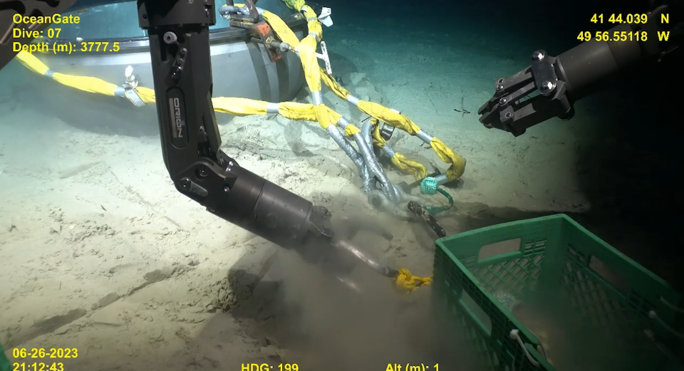 The remote-controlled robot picks at the Titan's wreckage