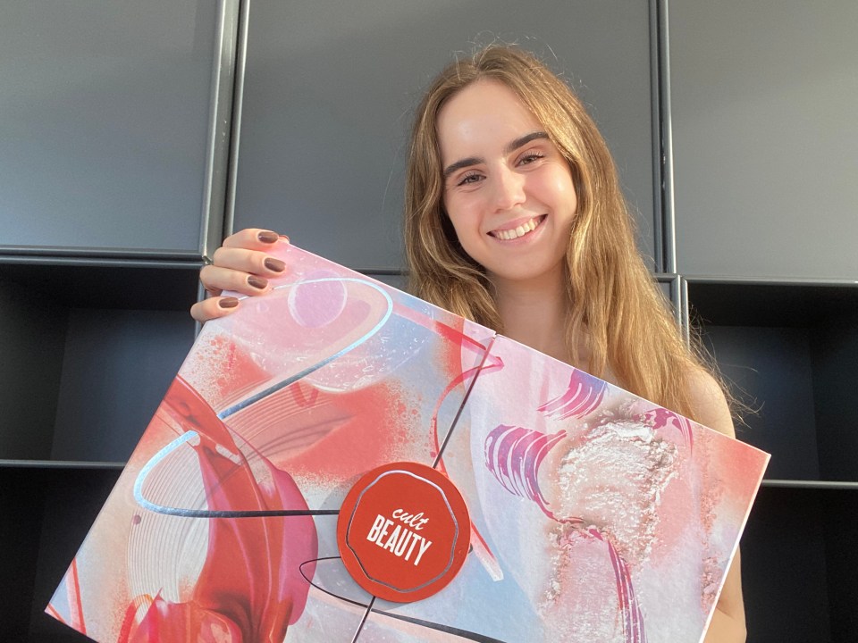 a woman holding a box that says safe beauty