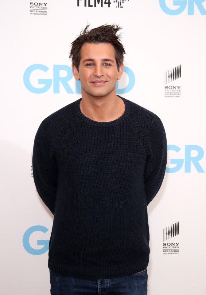 a man in a black sweater stands in front of a wall that says sony international