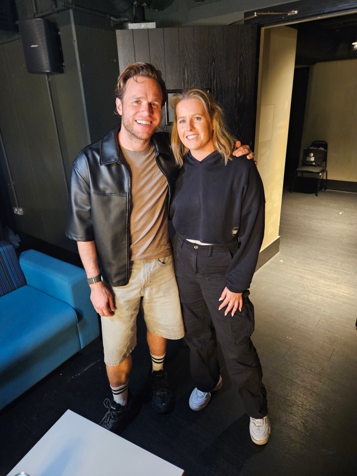 a man and a woman pose for a picture in a room