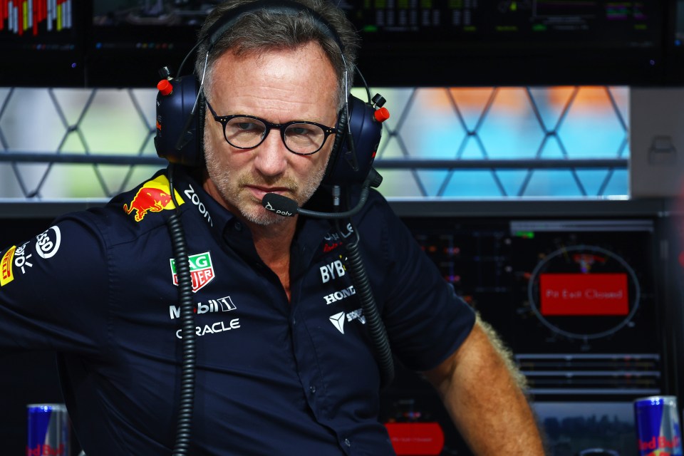 a man wearing headphones and a red bull shirt