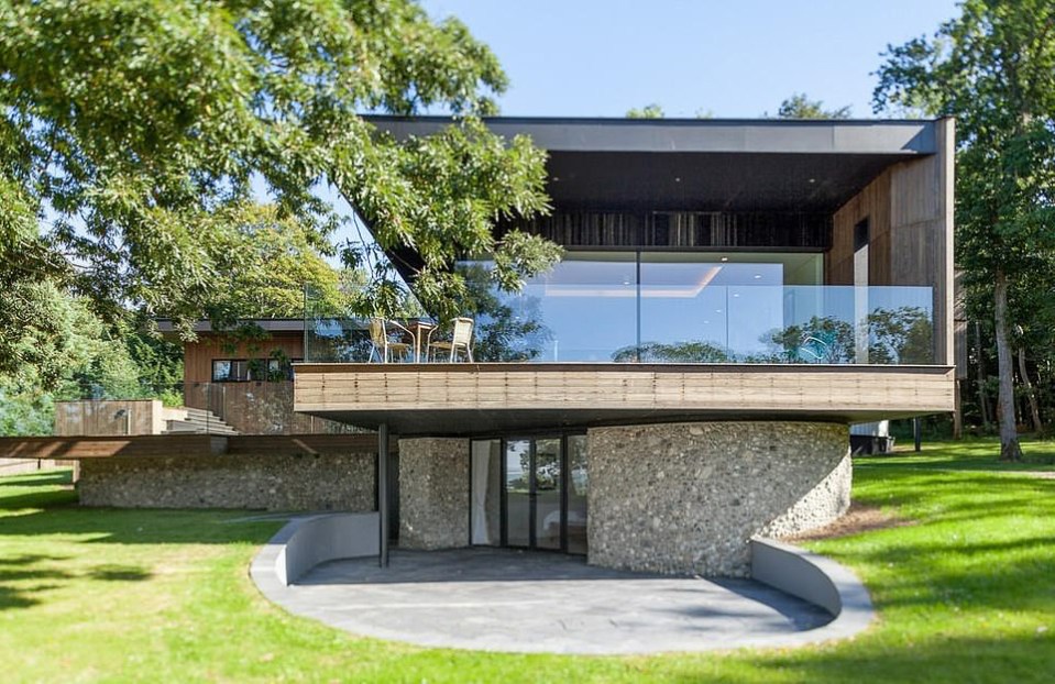 a modern house with a large glass balcony