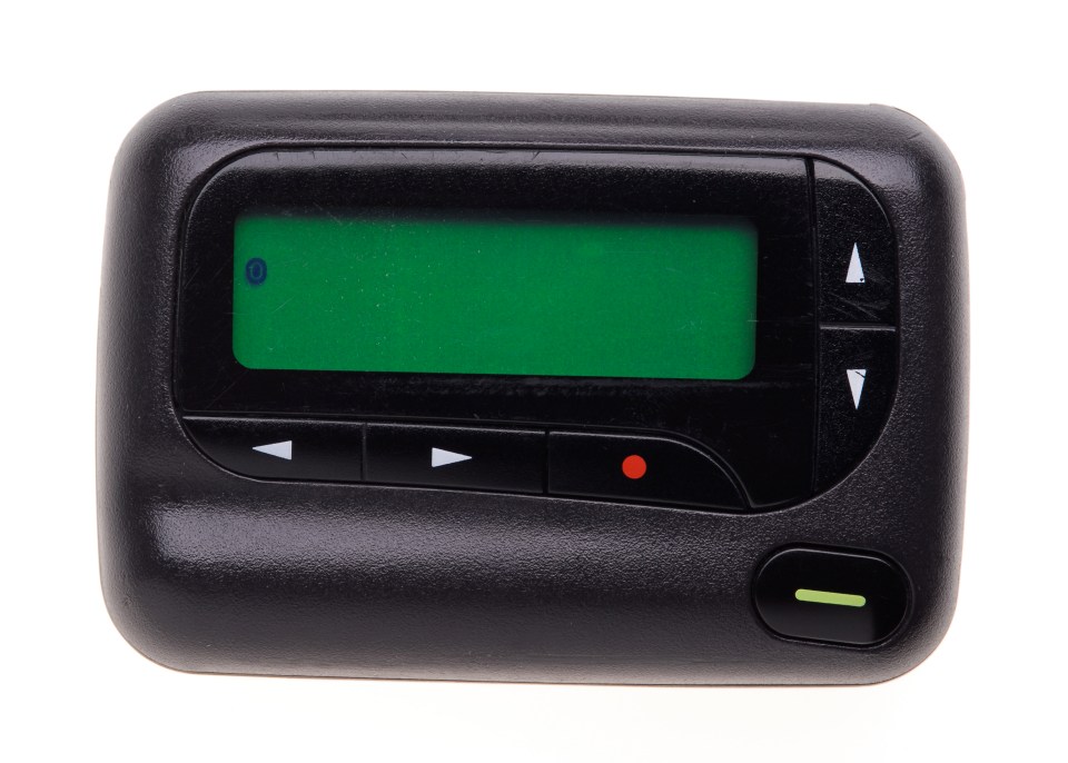 a black device with a green screen and a red button