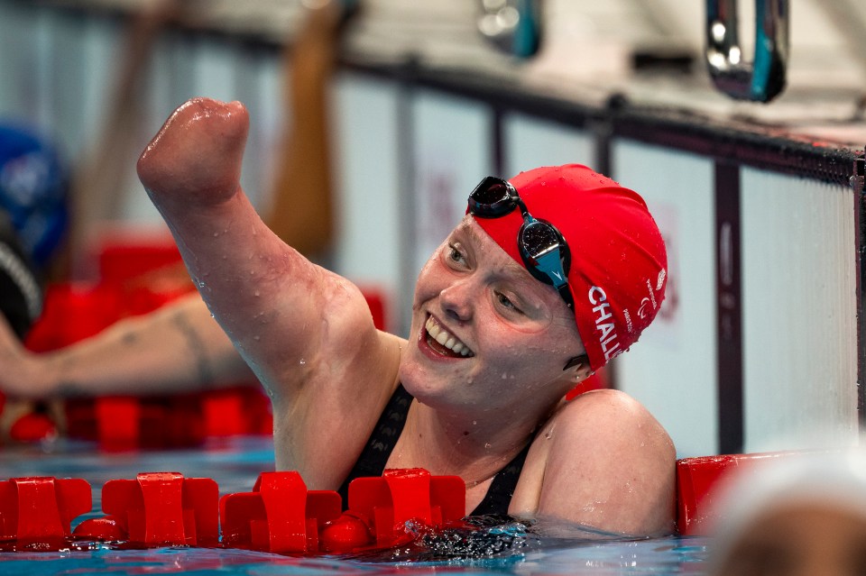 a female swimmer wearing a red hat that says challis on it