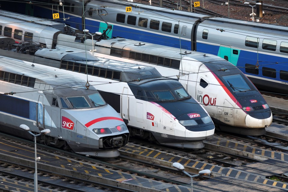 a row of trains with one that says sncf on the front