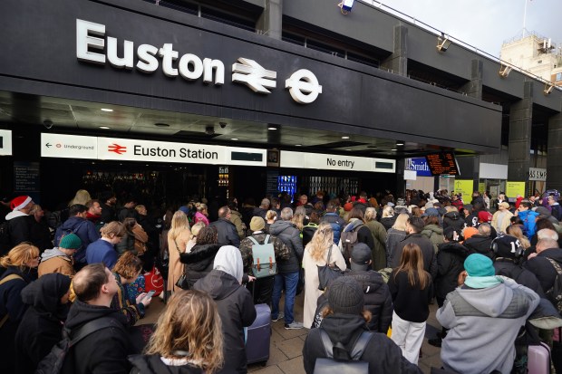 a crowd of people are gathered outside euston station