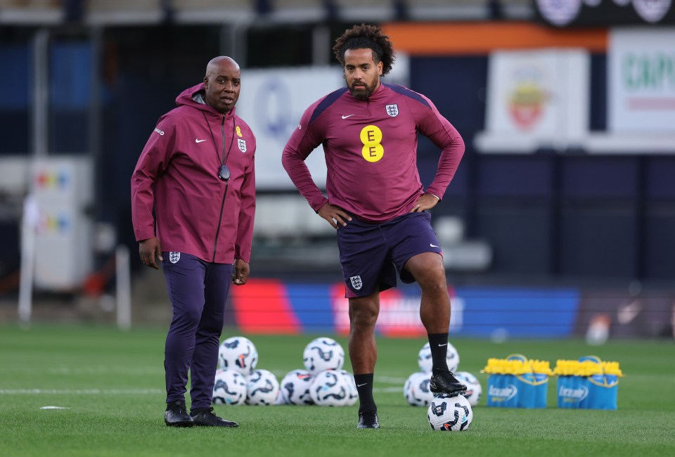 two men on a soccer field with one wearing an ee shirt