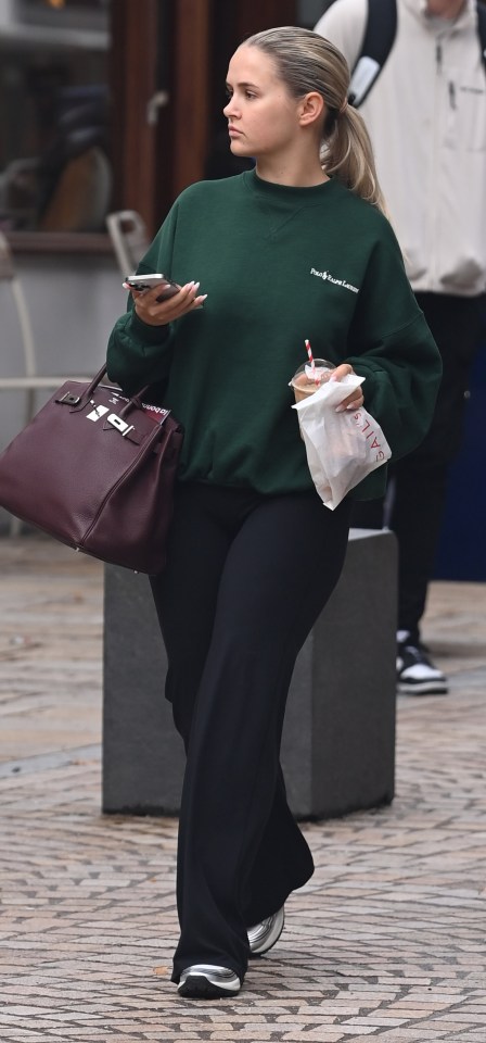 a woman wearing a green polo ralph lauren sweatshirt