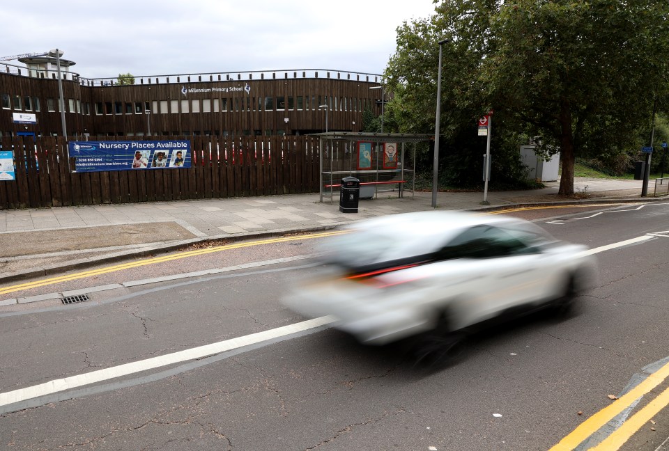 a white car is driving past a sign that says nursery places available