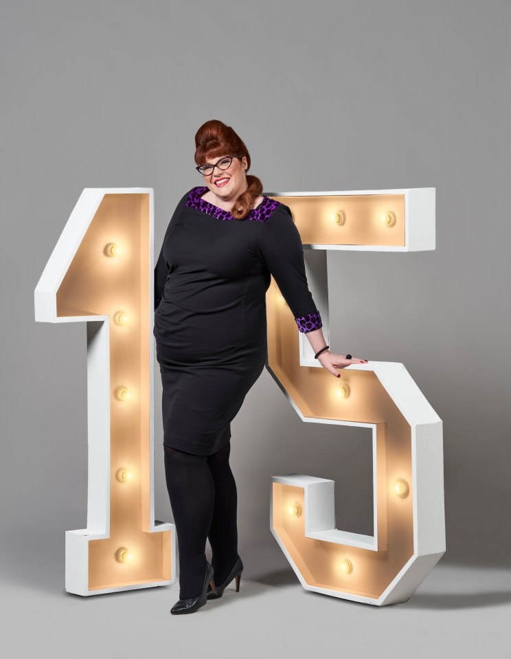 a woman leans against a large number 15