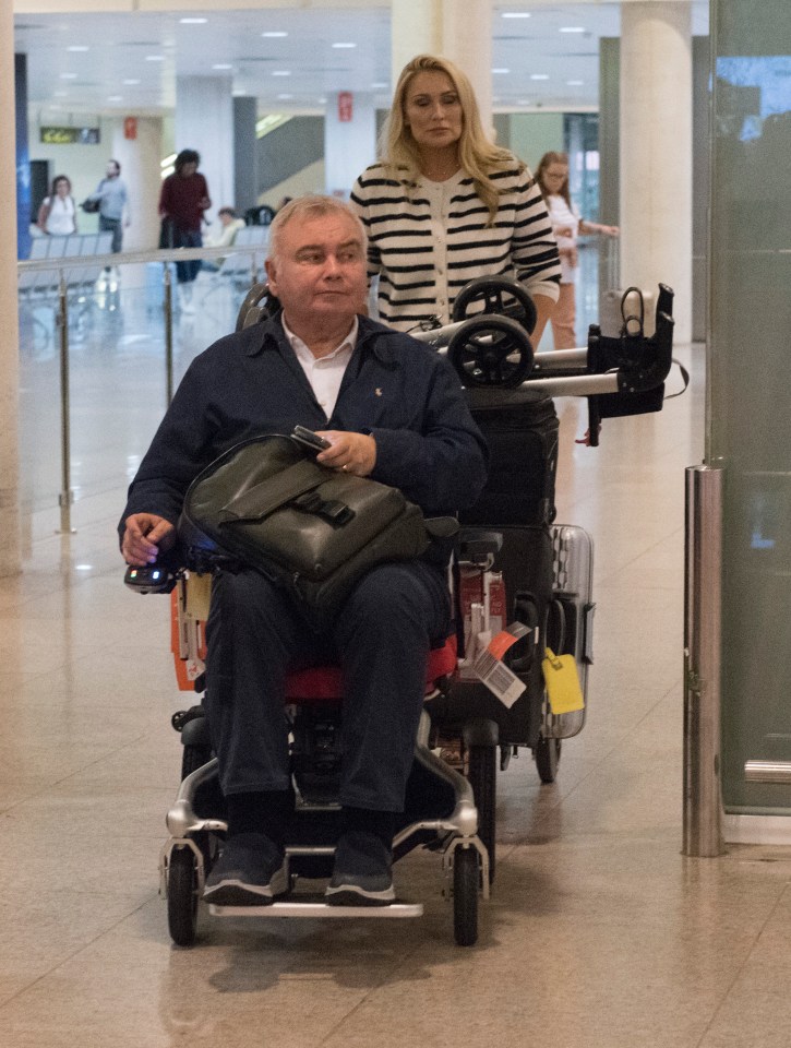 a man in a wheelchair is being pushed by a woman