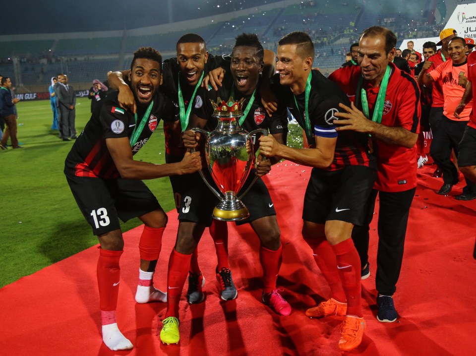 Players of Al Ahli Dubai celebrates as they receive the cup after their victory following the Arabian Gulf Super Cup in 2016