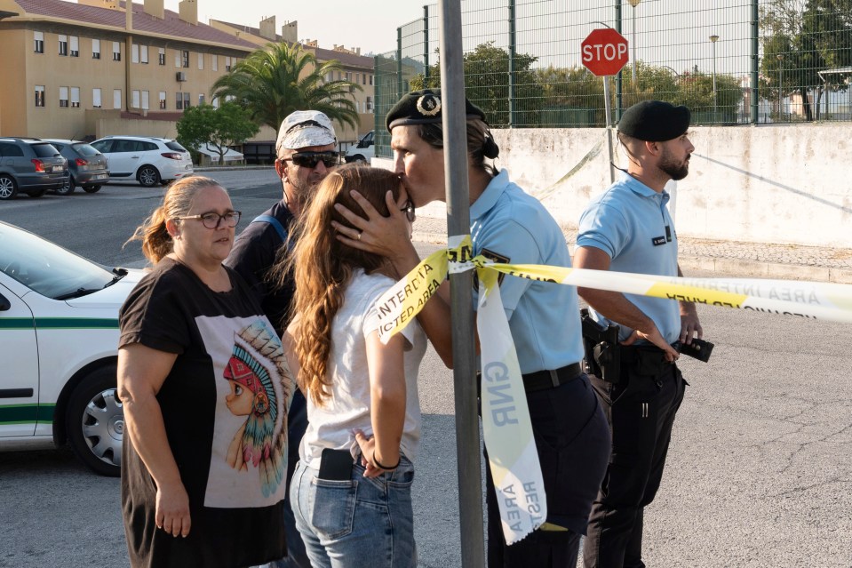 a group of people standing in front of a stop sign