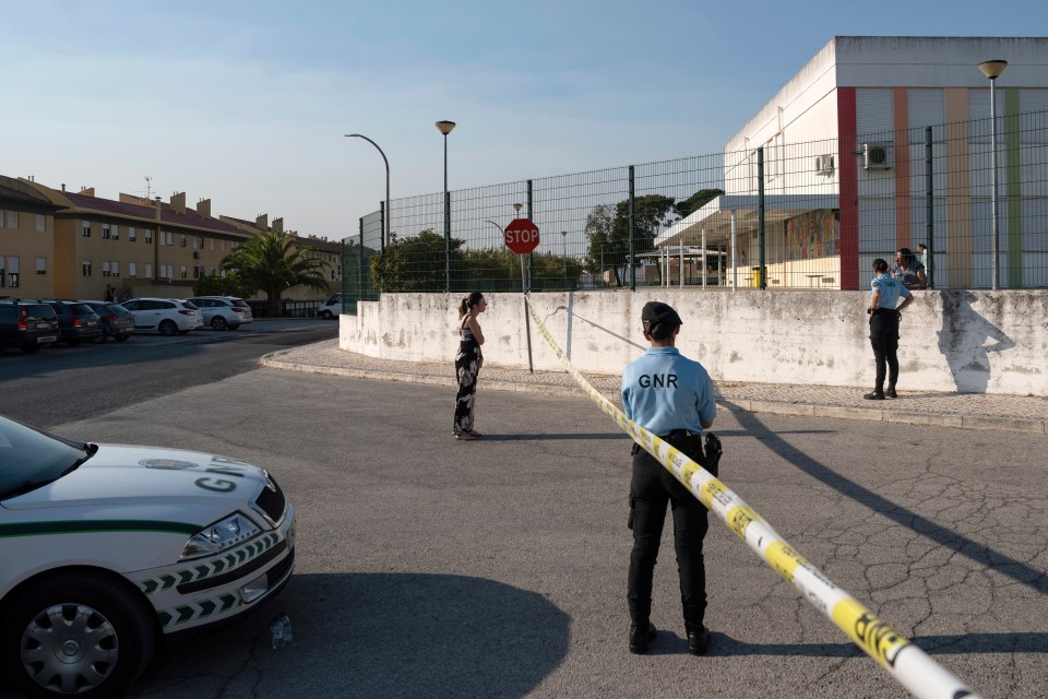 a gnr officer stands in front of a stop sign