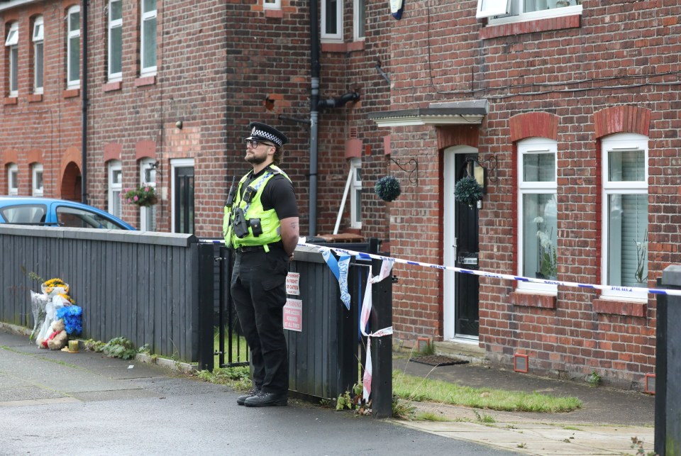 An officer stands guard at the cordon today