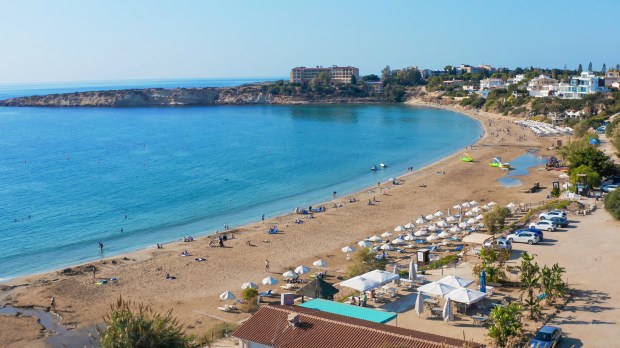 a beach with a lot of umbrellas and chairs