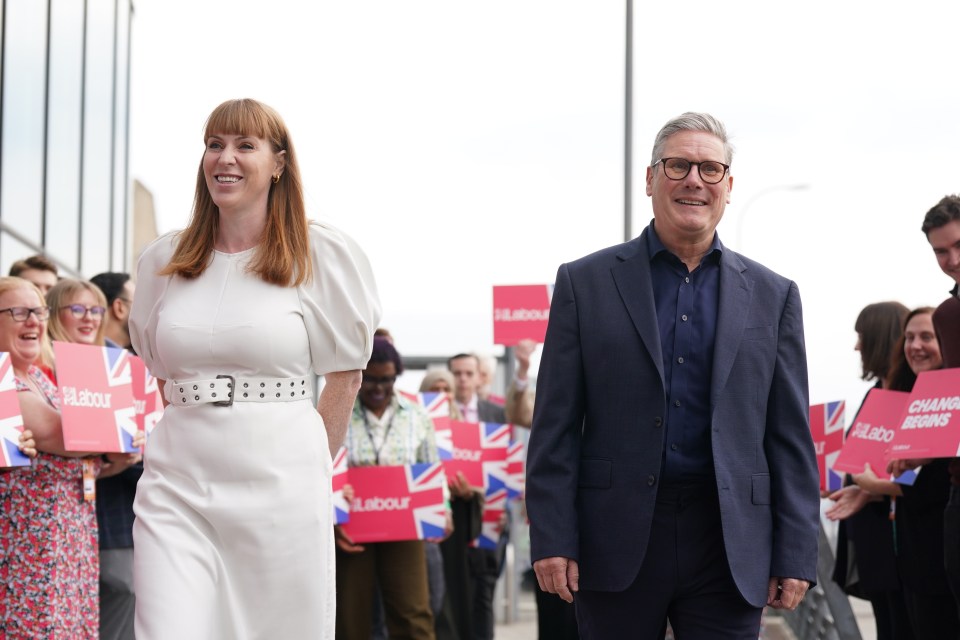 a man and a woman holding signs that say labour