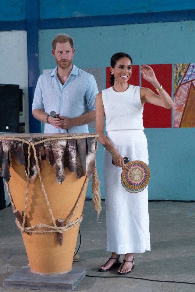 a man and a woman standing next to a drum