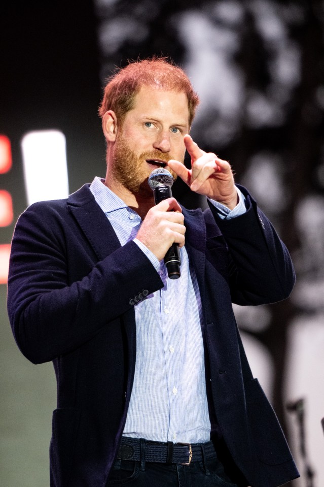 a man in a suit is speaking into a microphone