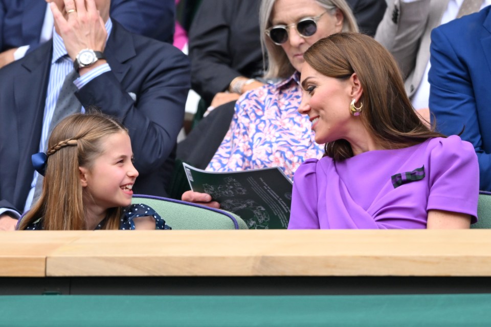 a woman in a purple dress sits next to a little girl