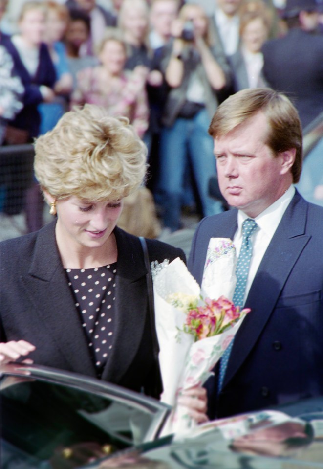 a man holds a bouquet of flowers next to a woman