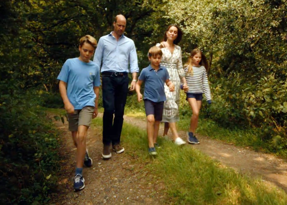 a family walking down a path in the woods