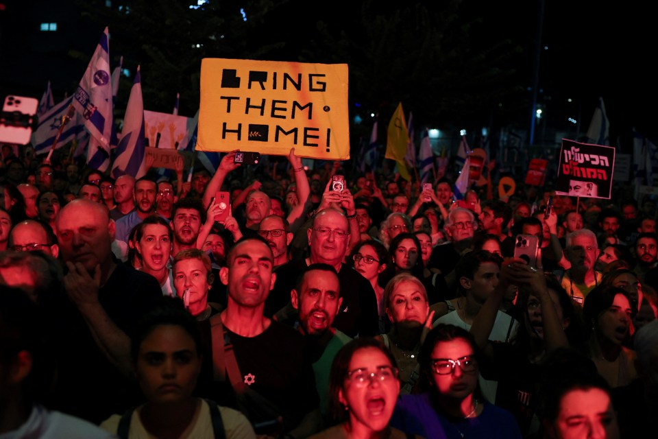 Protesters rally outside the Defence Ministry with signs that read 'Bring Them Home'