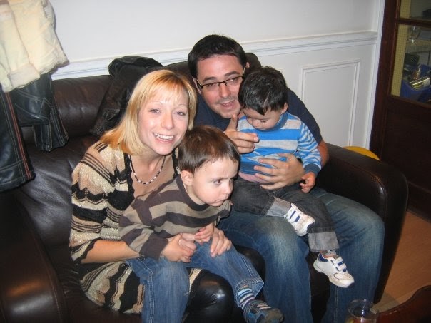 a family posing for a picture on a leather couch