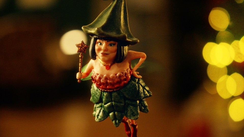 a christmas ornament of a fairy holding a wand