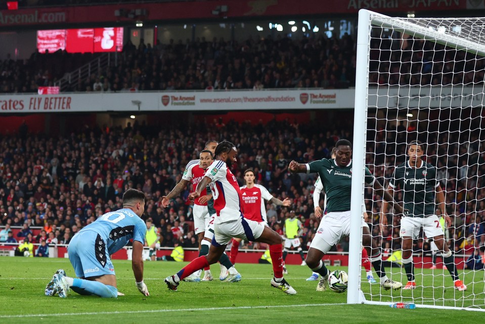 a soccer game is being played in front of a banner that says " the arsenal foundation "