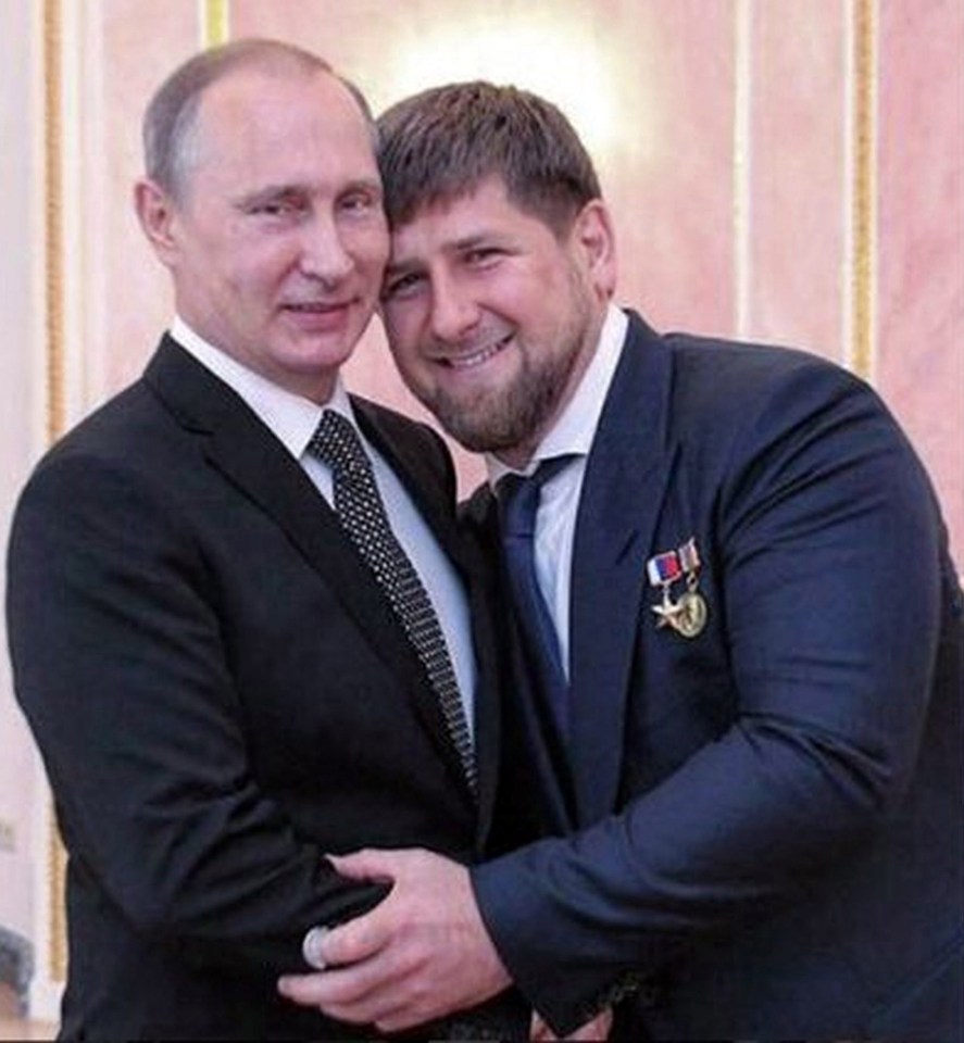 a man in a suit and tie is hugging another man in a suit and tie .