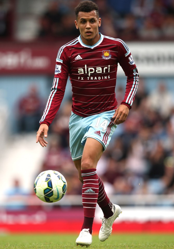 a soccer player wearing a maroon and blue jersey that says alpari fx trading