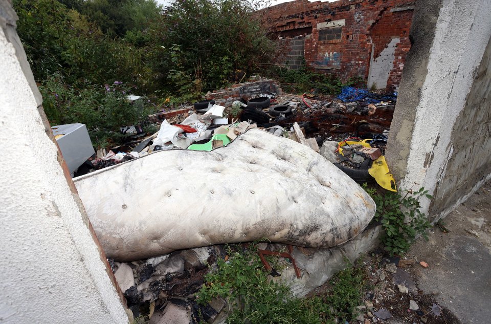 A dirty mattress, tyres and rubbish are strewn across one section on the estate