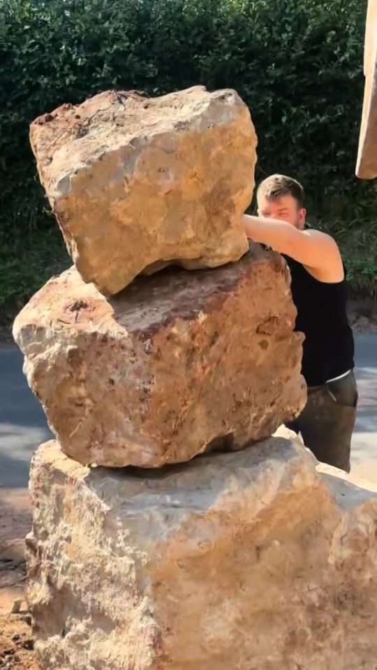 a man is stacking rocks on top of each other