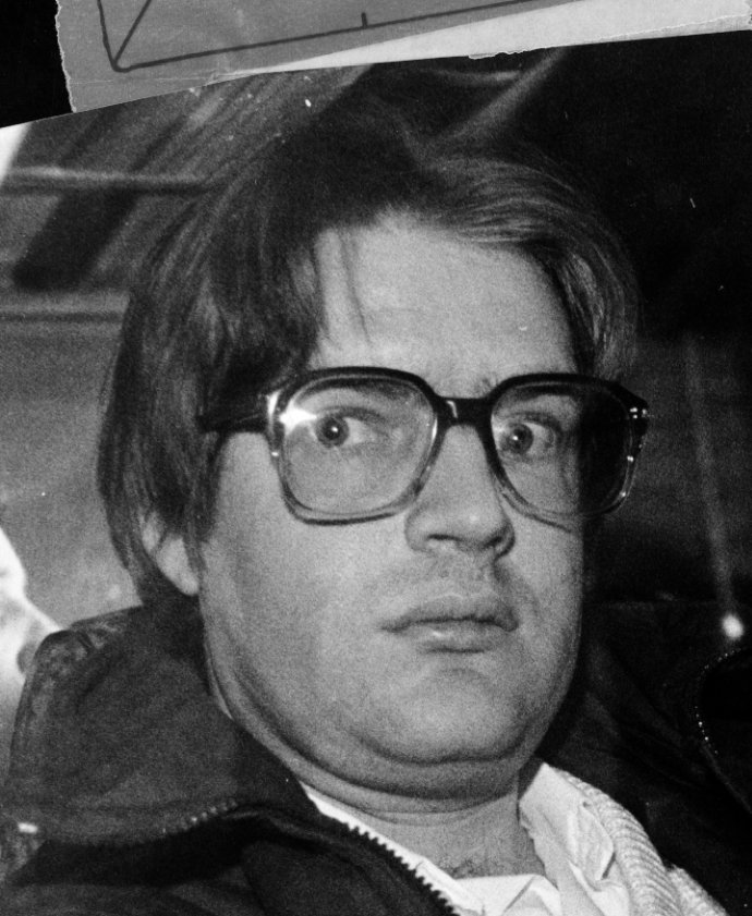 a black and white photo of a man wearing glasses