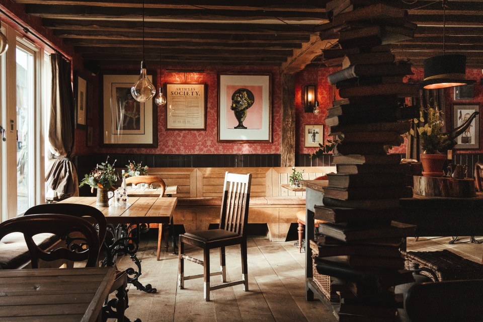 As well as a big open fireplace The Bell has exuberant art, top hats as lampshades, and uneven floors