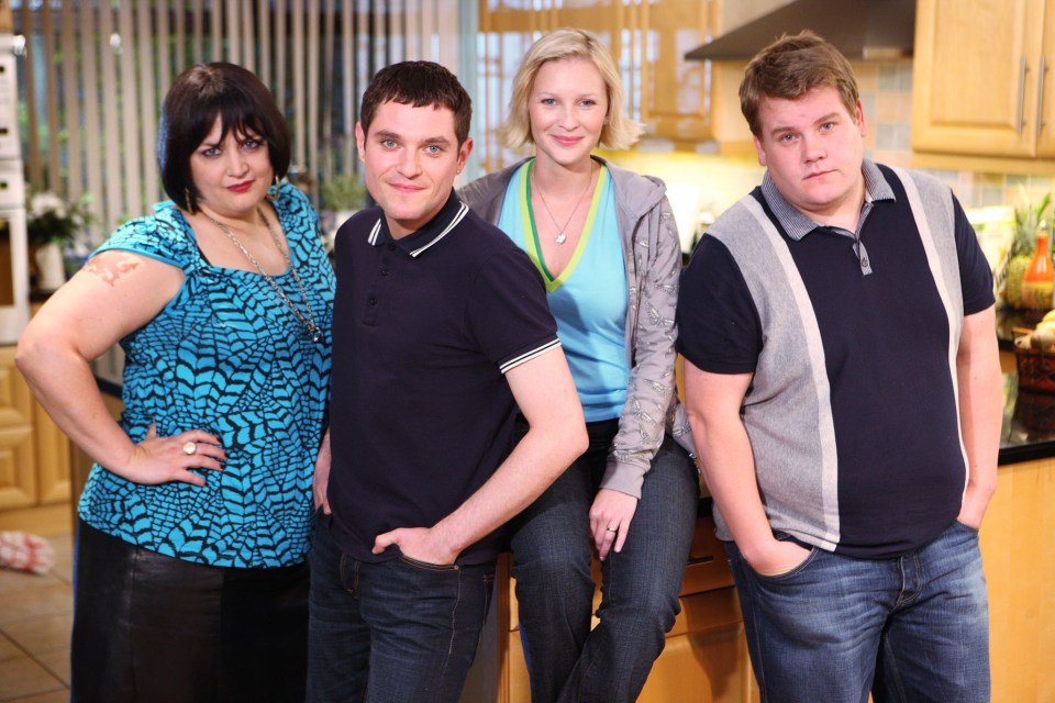 a group of people posing for a picture in a kitchen