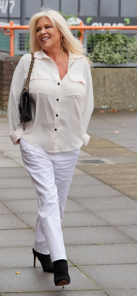 Sam wore a white blouse and trousers when she was sentenced