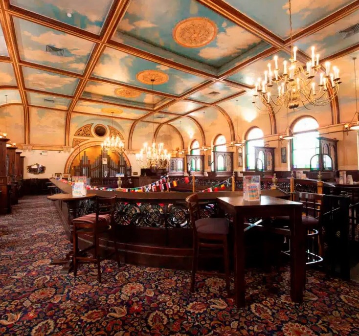 a large room with a blue sky painted on the ceiling