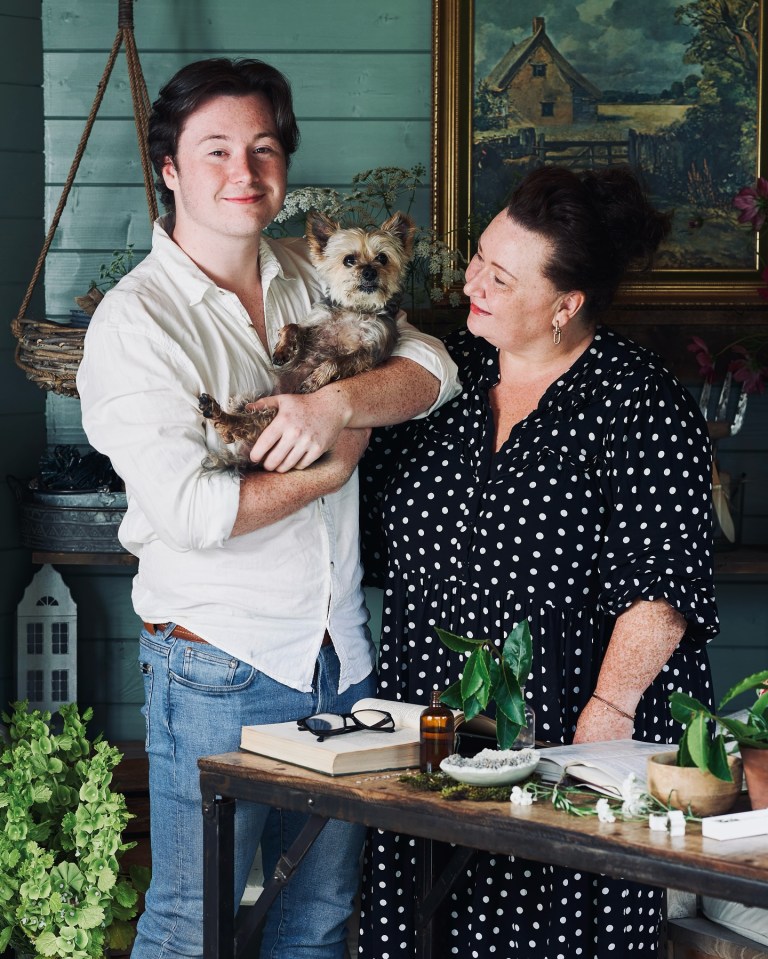 a man and a woman holding a small dog