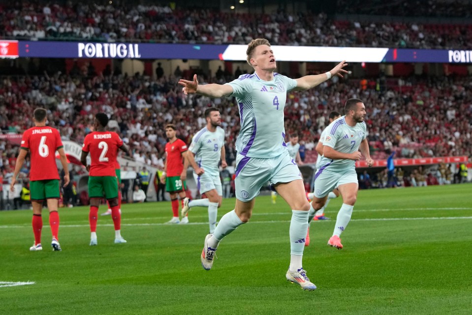 soccer players on a field with a portugal sign in the background