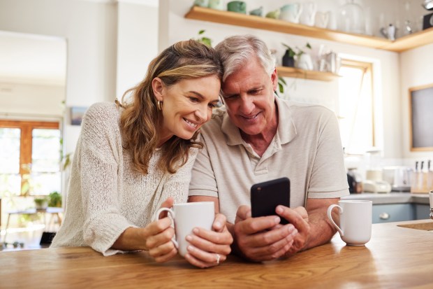 Senior couple looking at a smartphone together.