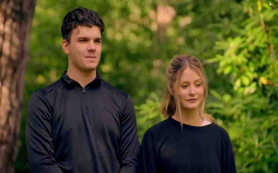 a man in a black under armour shirt stands next to a woman